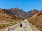 Two adventure motorcycles on Ruta Nacional 7, crossing the Argentine Andes toward the Chilean border.